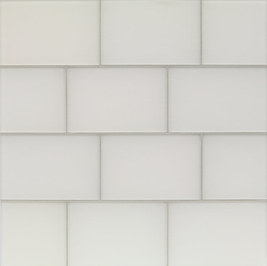 Tomei Modules 6" x 9" Ceramic Tile in Silk features white rectangular tiles set in a staggered brick pattern with light gray grout, offering a clean, minimalist style perfect for modern interiors.