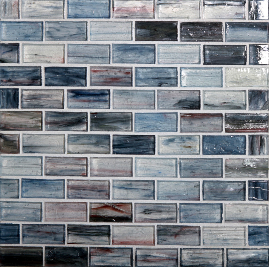 A wall of Tozen Brick Mosaic Tile in Natural color, featuring a brick pattern with glossy surfaces in blue, gray, and white tones with subtle marbling.