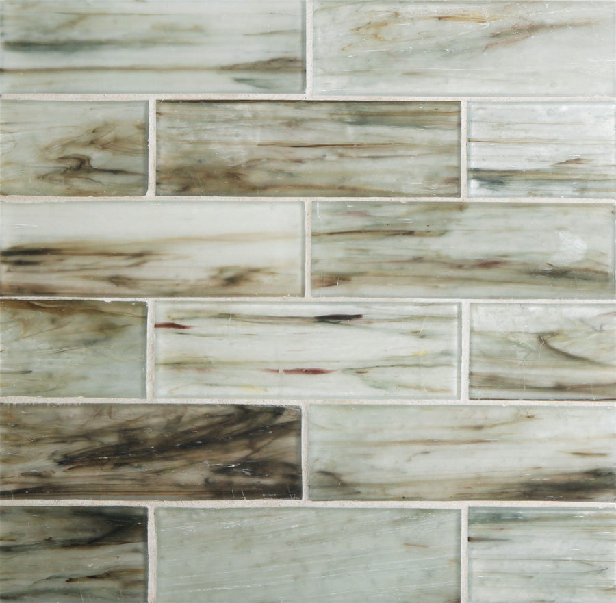 Close-up of Tozen 2" x 6" Nickel Subway Tile in Silk, arranged in a staggered pattern with a glossy finish. Marble-like swirls in white, gray, beige, and brown are highlighted by thin white grout lines—ideal for kitchen backsplashes.