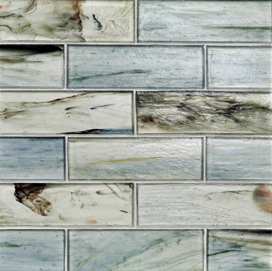 Close-up of Tozen 2" x 6" Oxygen Subway Tile in Natural, arranged in a staggered pattern. This premium tile features a marbled look with gray, white, green, and brown tones—an elegant choice for kitchen backsplashes.