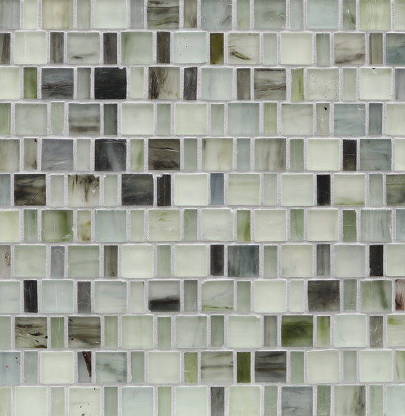 A close-up of a wall featuring Tozen Japonaise Mosaic Tile in the color Silk, arranged in a grid pattern that reflects Japanese aesthetics with white, gray, green, and cream tones.