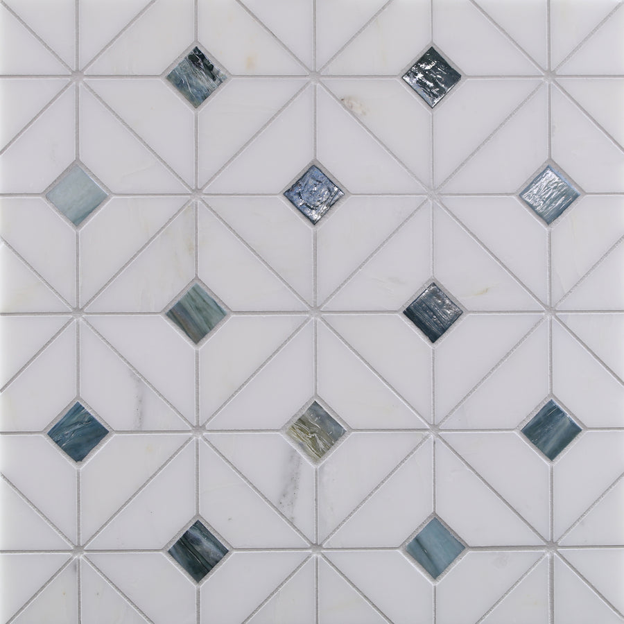 The Vesuvio Quilt Mosaic Tile in Palisades features a matte white, geometric triangle pattern with multicolored reflective glass accents, ideal for creating modern backsplashes or accent walls.