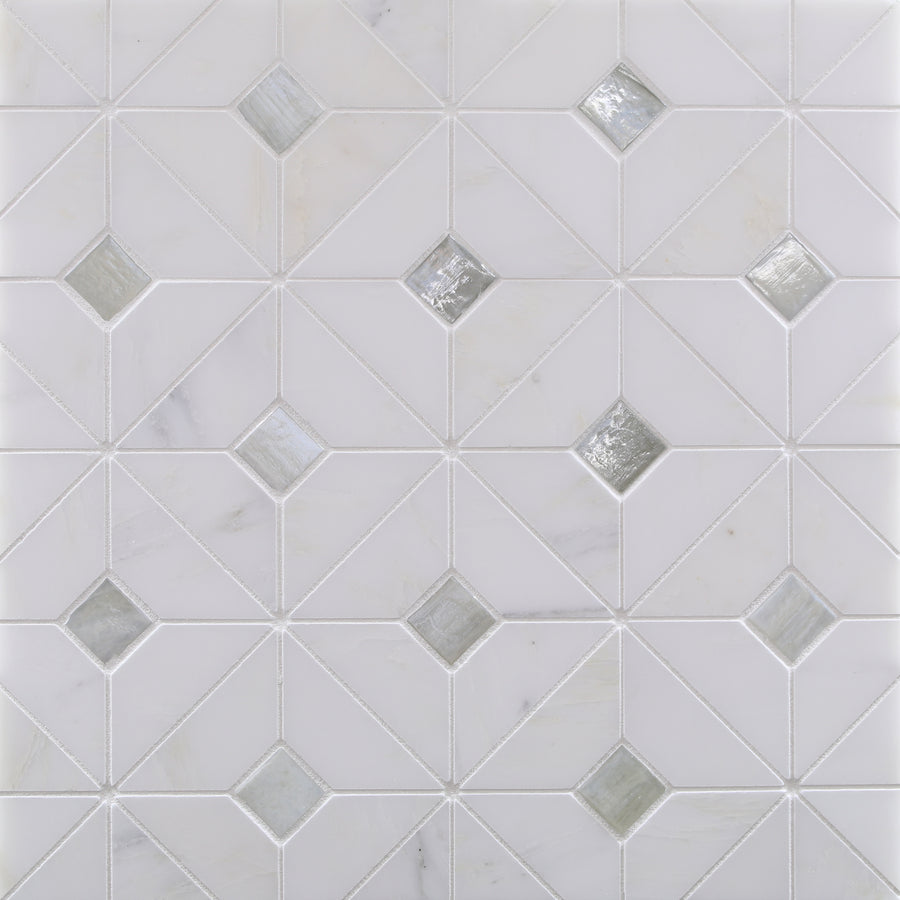 A white tile surface features Vesuvio Quilt Mosaic Tile in White Mountain, with diagonal lines forming diamonds and some tiles filled with reflective glass—ideal for modern backsplashes or accent walls.