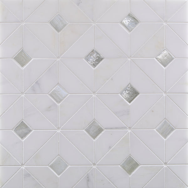 A white tile surface features Vesuvio Quilt Mosaic Tile in White Mountain, with diagonal lines forming diamonds and some tiles filled with reflective glass—ideal for modern backsplashes or accent walls.