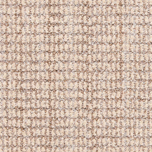 Close-up of the Aspen Berber Carpet in Latte shows its looped, grid-like pattern. The tightly woven fibers create a durable, uniform surface with subtle beige variations for understated elegance.