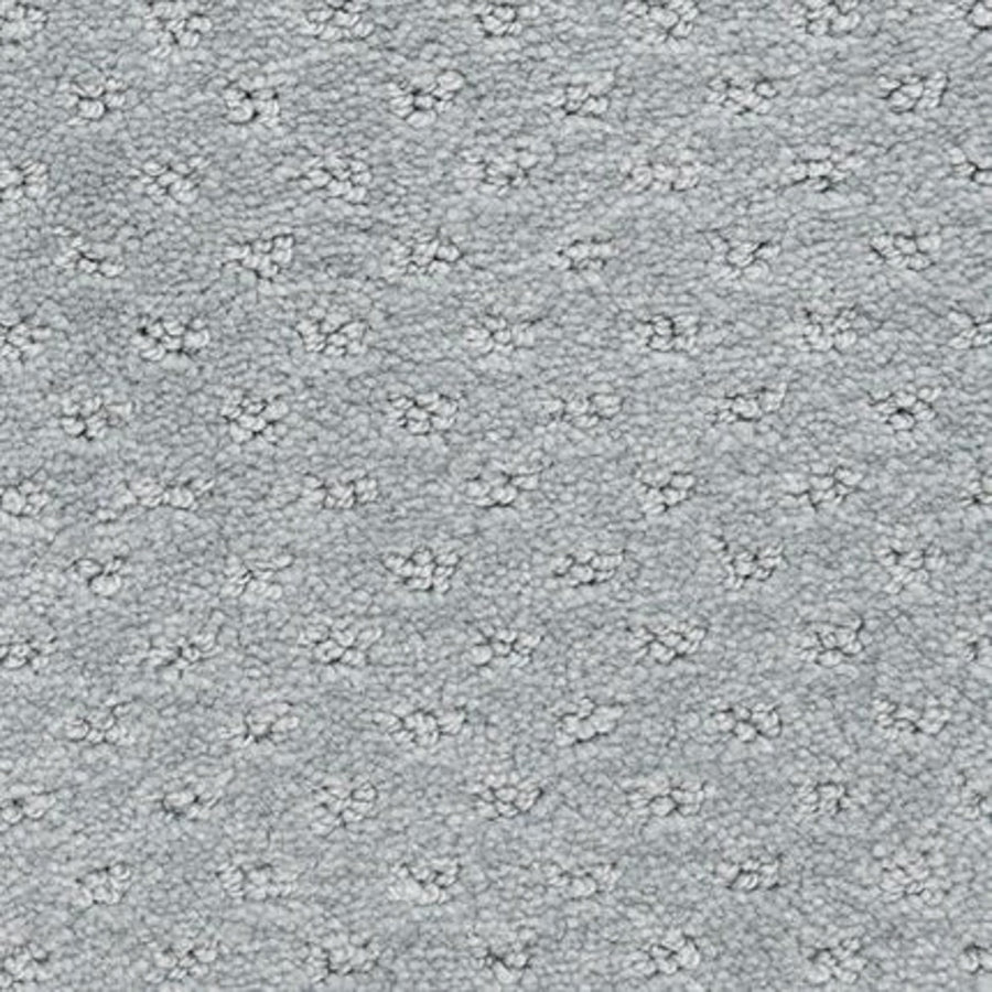 Close-up of Dreamer On Trend Carpet in Laurel color, featuring durable plush fibers with evenly spaced, raised floral or star-shaped patterns—an elegant option for luxury flooring.