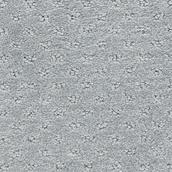 Close-up of Dreamer On Trend Carpet in Laurel color, featuring durable plush fibers with evenly spaced, raised floral or star-shaped patterns—an elegant option for luxury flooring.