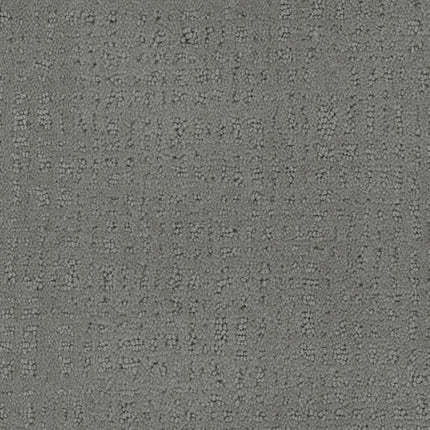 Close-up of the Homage Berber Carpet in Le Jardin, featuring a gray textured surface with subtle dotted and dashed patterns. Its understated, modern design is ideal for high-traffic areas, offering a tactile and slightly raised feel.
