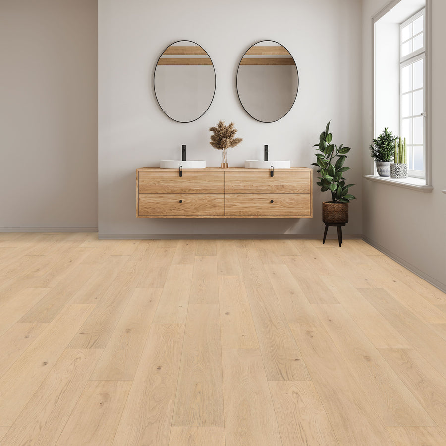 A modern bathroom with Woodlette Estates 7 1/2" Waterproof Laminate in a light wood look, a floating wooden vanity, two round mirrors, black faucets, and decorative plants by a large window.