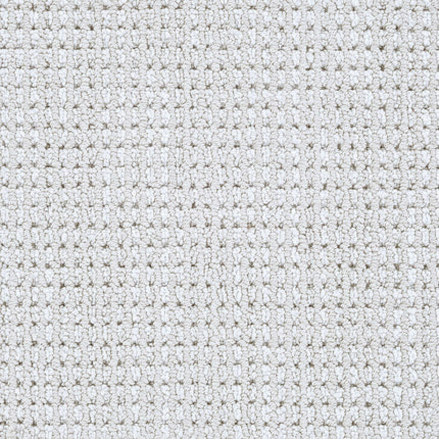 Close-up of Top Notch Berber Carpet in Linen—this textured, light gray flooring features a grid-like woven pattern with small raised squares and offers premium, stain-resistant durability.