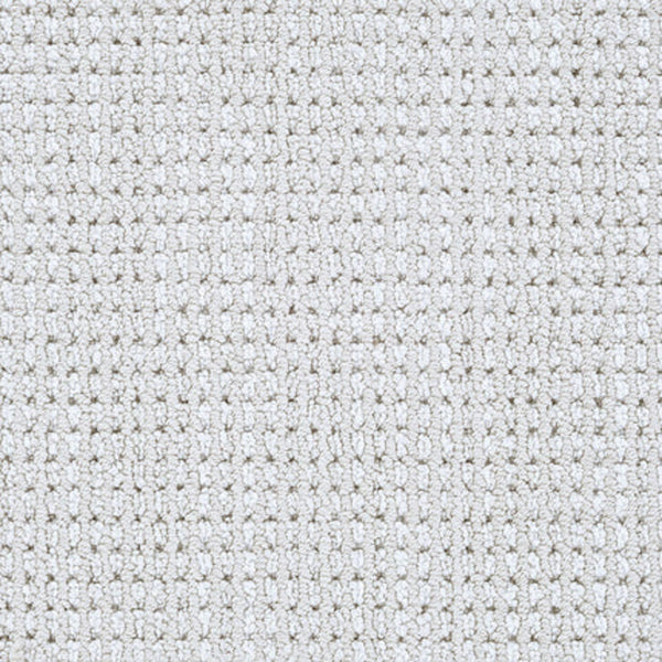 Close-up of Top Notch Berber Carpet in Linen—this textured, light gray flooring features a grid-like woven pattern with small raised squares and offers premium, stain-resistant durability.