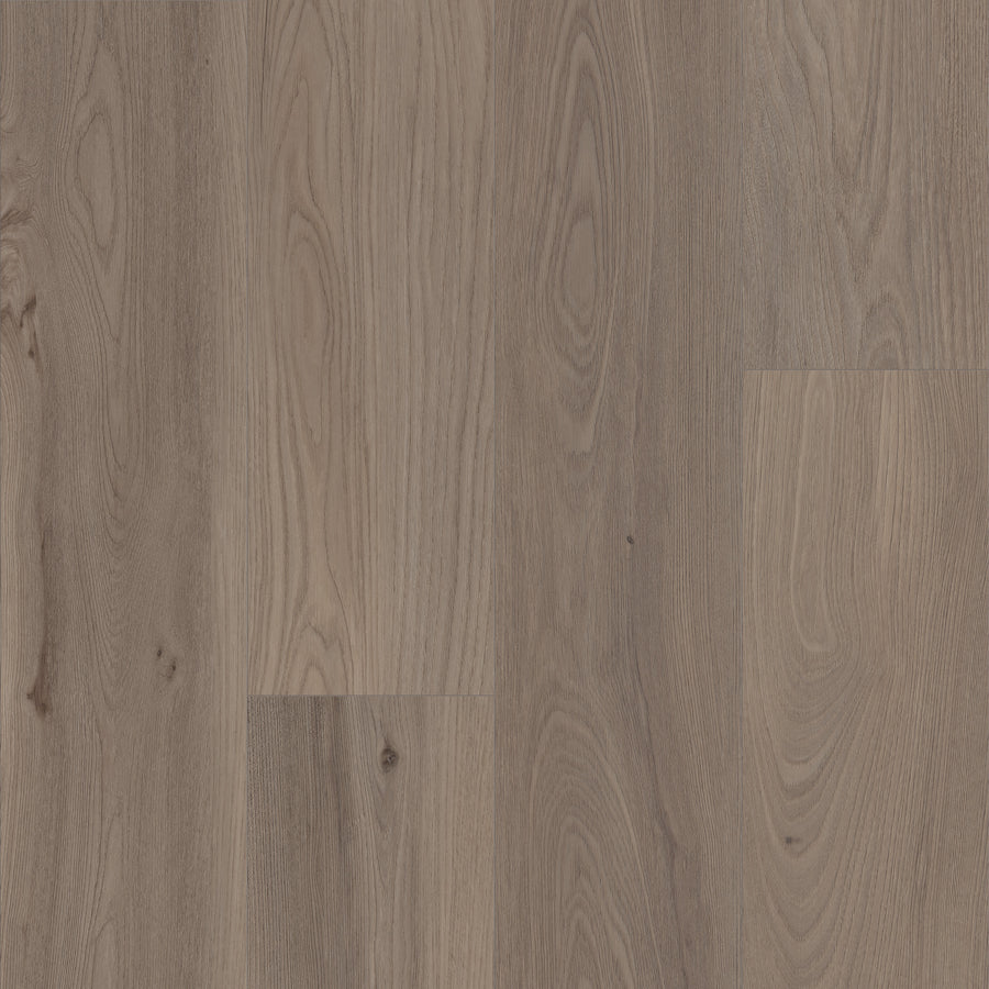 Close-up of Coretec Pro Plus XL Enhanced Vinyl flooring featuring natural light brown wood grain patterns, knots, and subtle variations. Combines stunning wood and stone looks with durable, waterproof performance for a warm, textured appeal.