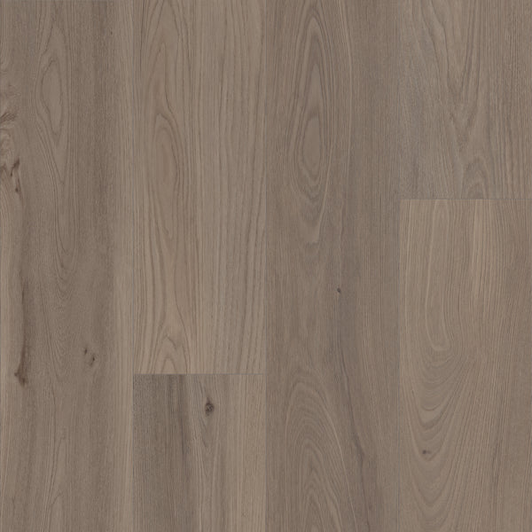 Close-up of Coretec Pro Plus XL Enhanced Vinyl flooring featuring natural light brown wood grain patterns, knots, and subtle variations. Combines stunning wood and stone looks with durable, waterproof performance for a warm, textured appeal.