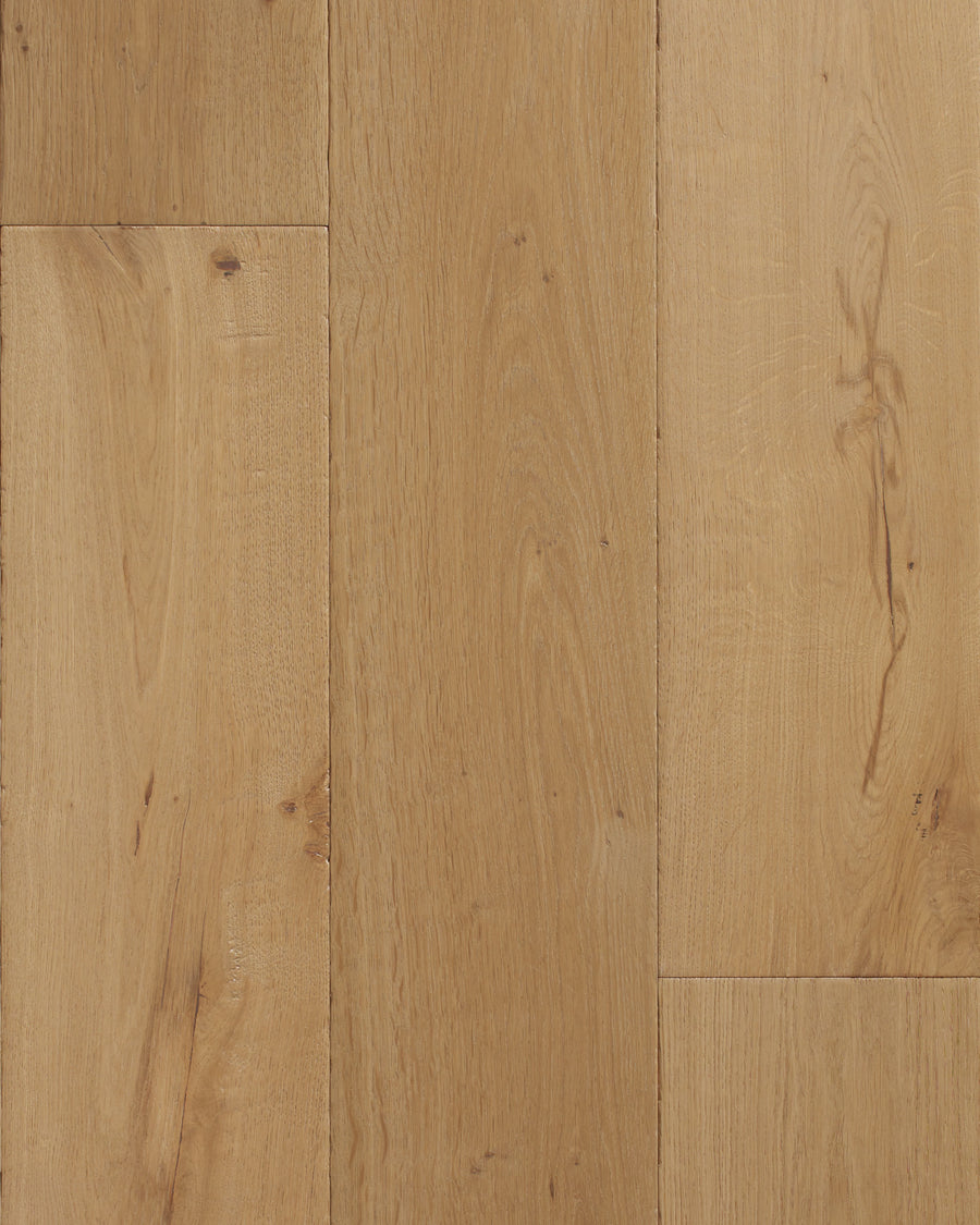 Close-up of Villa Borghese 8" French Oak in Ludovico shows light brown planks with natural grain, knots, and subtle color variation. The ultra low gloss urethane finish adds scratch resistance and a smooth, polished look.