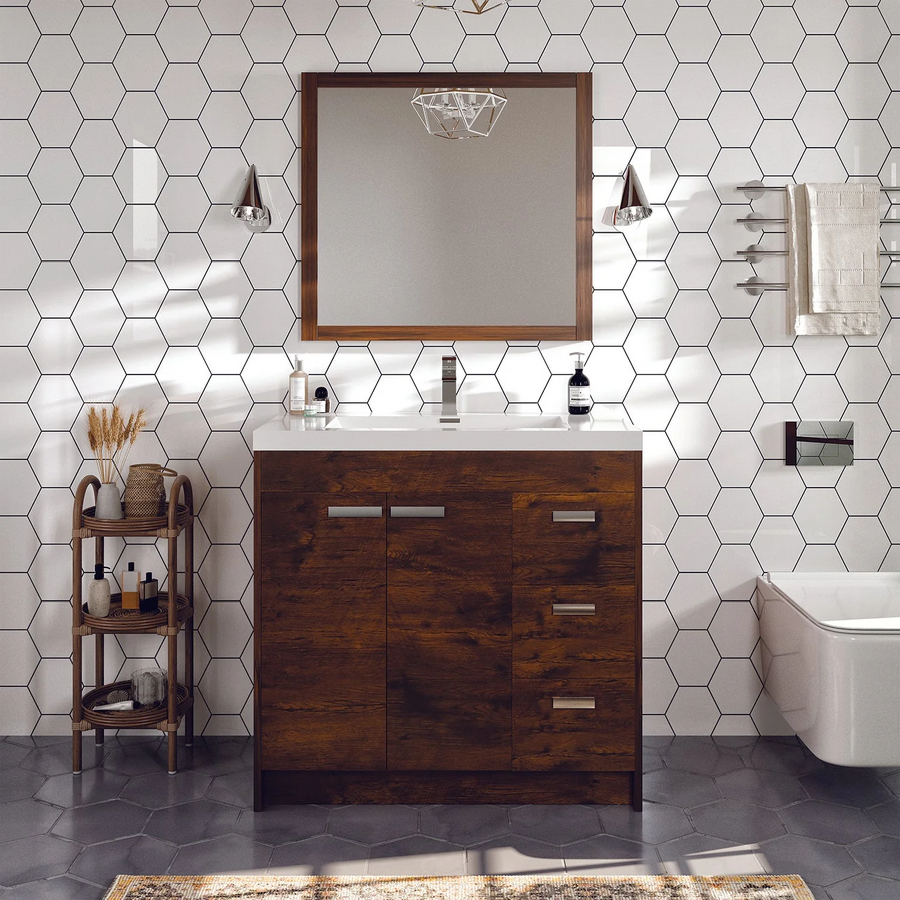 A modern bathroom with hexagonal white wall tiles, the Lugano 36" Vanity featuring a white countertop and integrated acrylic sink, a rectangular mirror, metal sconces, a floating toilet, and a shelf with accessories.
