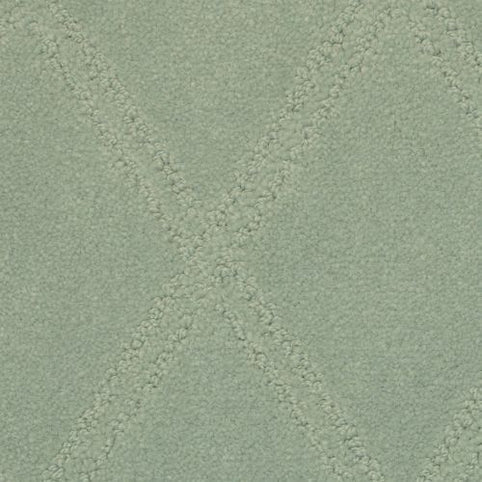 Close-up of the Braided Opulence Berber Carpet in Luna, featuring a light green hue with a raised, textured diamond pattern and intersecting crisscross design. The plush surface offers a soft, luxurious feel.