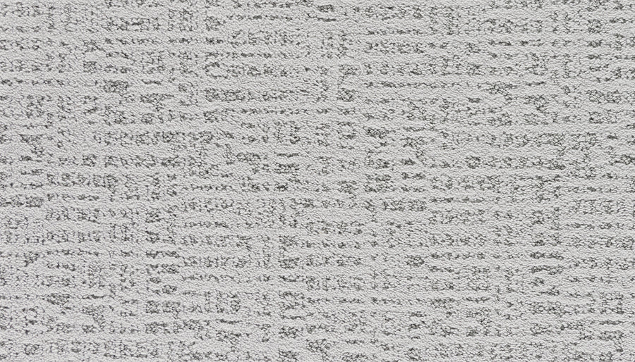 Close-up of Luxuriant Path Pet Friendly Carpet in Flute, a light gray, stain-resistant carpet with a textured surface and subtle irregular grid pattern featuring raised, slightly darker sections.