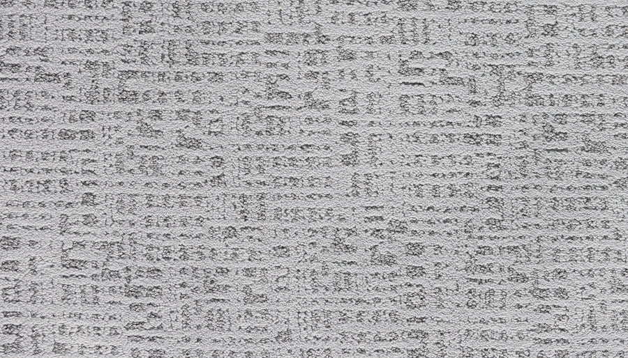 Luxuriant Path Pet Friendly Carpet in Lincoln is a light gray, textured carpet with a subtle, irregular grid and block pattern. Its durable, stain-resistant surface features raised and recessed areas for a modern, soft geometric look.