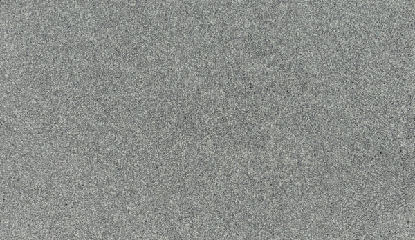 A close-up of the Luxuriant Touch III Pet Friendly Carpet in Lincoln, showing its smooth gray surface and fine, speckled texture that highlights its durability and easy maintenance.