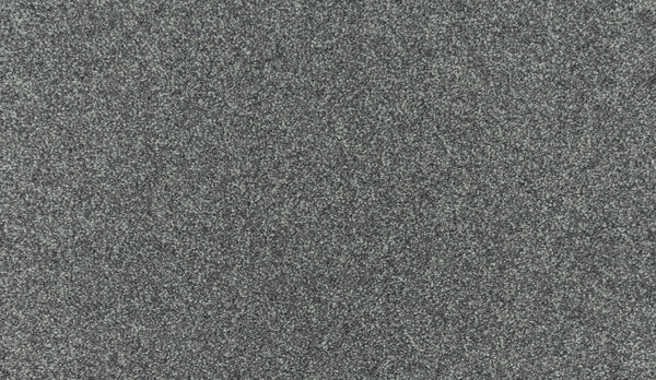 Close-up of Luxuriant Touch III Pet Friendly Carpet in Pavement color, featuring a rough, dark grey textured surface with fine, densely packed granules creating a speckled pattern.