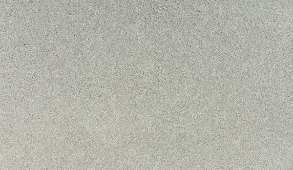 A close-up of Luxuriant Touch I Pet Friendly Carpet in Seagull color displays a flat, gray textured surface with subtle speckles—offering stain resistance and stylish appeal, ideal for premium flooring in pet-friendly homes.