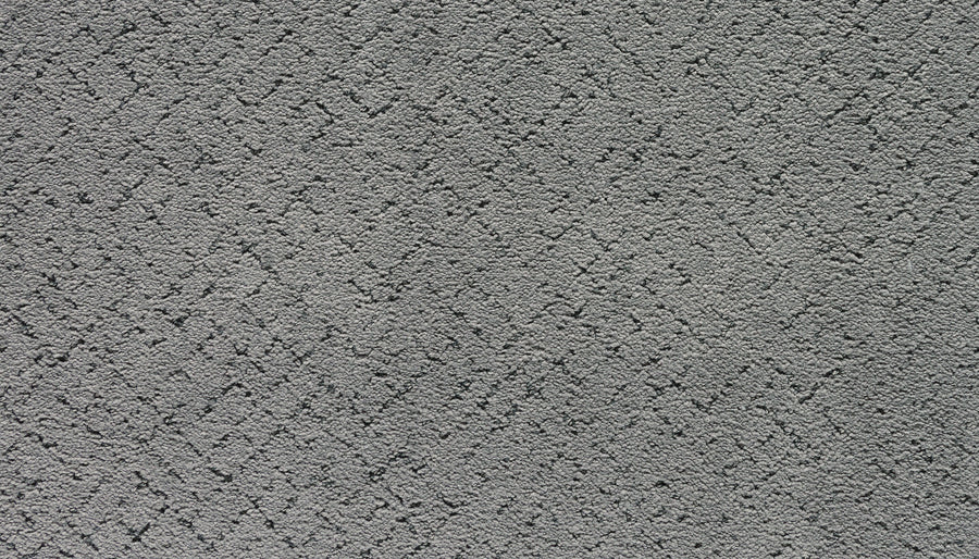 Close-up of the Luxuriant Weave Pet Friendly Carpet in Chroma, featuring a gray textured surface with a subtle crisscross diamond pattern. Its soft, slightly raised texture offers durability and a modern geometric look.
