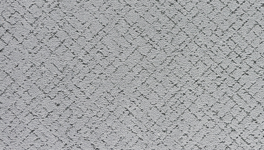 Close-up of Luxuriant Weave Pet Friendly Carpet in Lincoln—a light gray shade with a soft, luxurious texture and subtle intersecting lines. Its raised, modern abstract design is ideal for pet-friendly spaces.