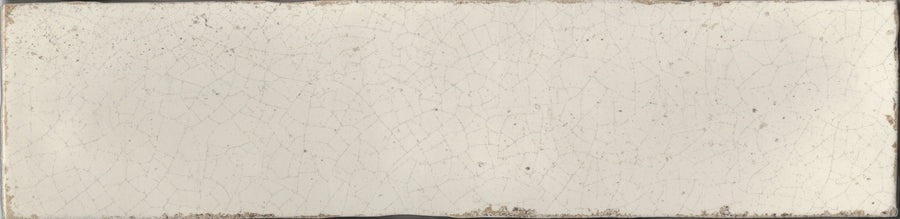 The Maiolica 3x12 Crackled Ceramic Subway Tile features an off-white, rectangular design with a visible crackle pattern and gently worn edges, capturing the timeless appeal of classic Maiolica craftsmanship.