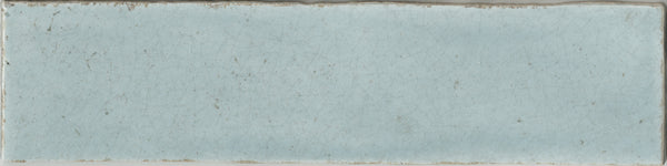 The Maiolica 3x12 Crackled Ceramic Subway Tile features a rectangular, light blue design with a slightly uneven surface, fine crackles, and worn edges for a vintage, weathered look.