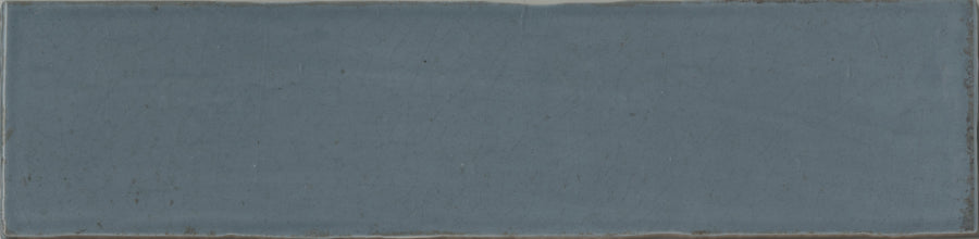 The Maiolica 3x12 Crackled Ceramic Subway Tile is a rectangular blue tile with a weathered, crackled surface, subtle color variations, and darker irregular edges for a luxurious appeal.