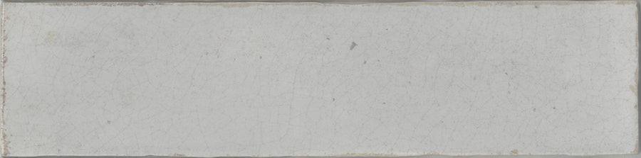 The Maiolica 3x12 Crackled Ceramic Subway Tile features a rectangular, off-white design with a slightly rough texture, fine crackle details, and weathered edges for an authentic luxury appearance.