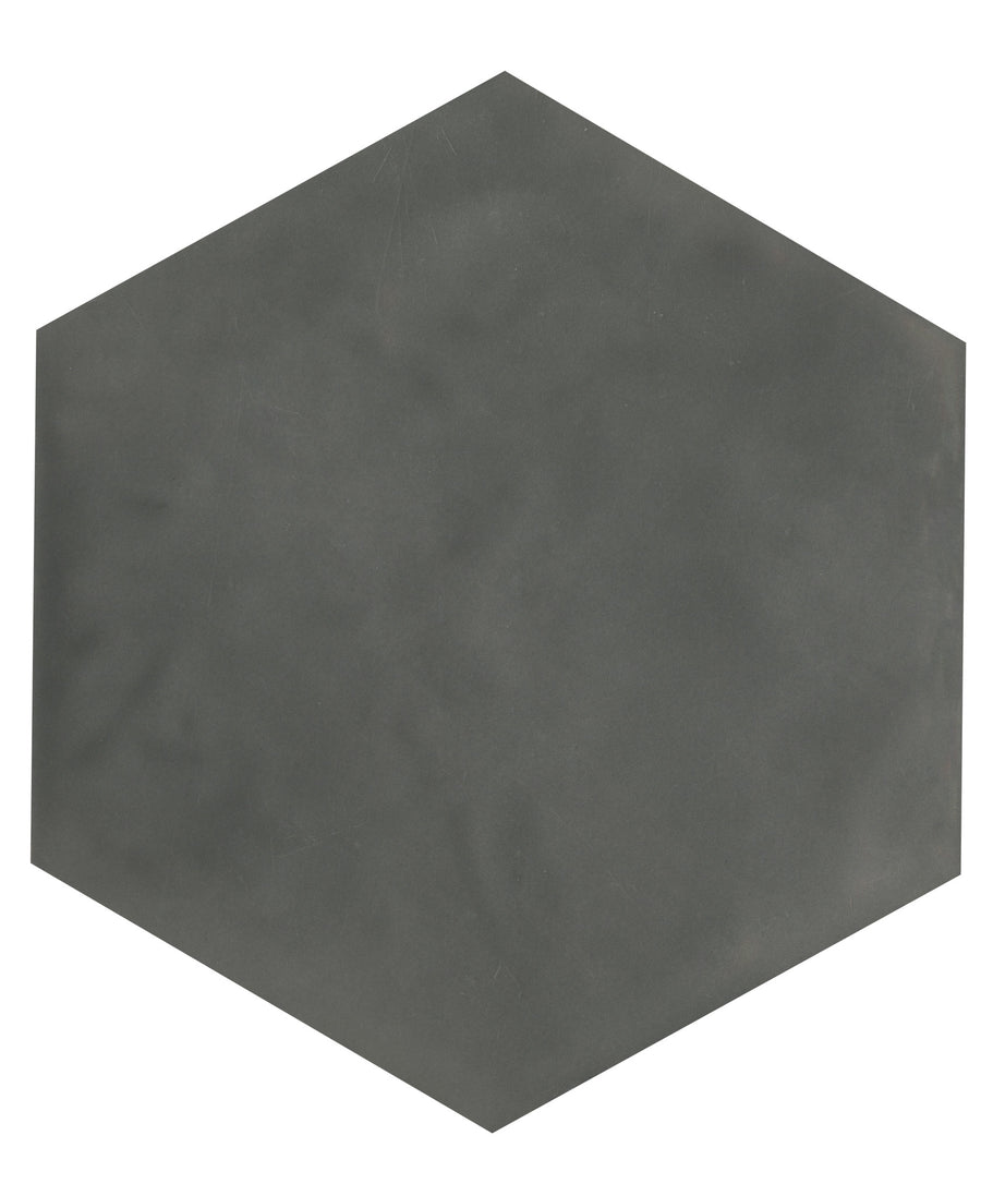 The Maiolica 7x8 Hexagon Ceramic Tile, in a plain dark gray finish, rests on a white background, blending modern minimalism with timeless elegance.