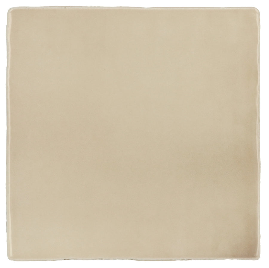 The Manacor 4" x 4" Ceramic Tile in Beige Argile features a soft, velvety texture and slightly rounded edges, evoking Spanish elegance against a white background.