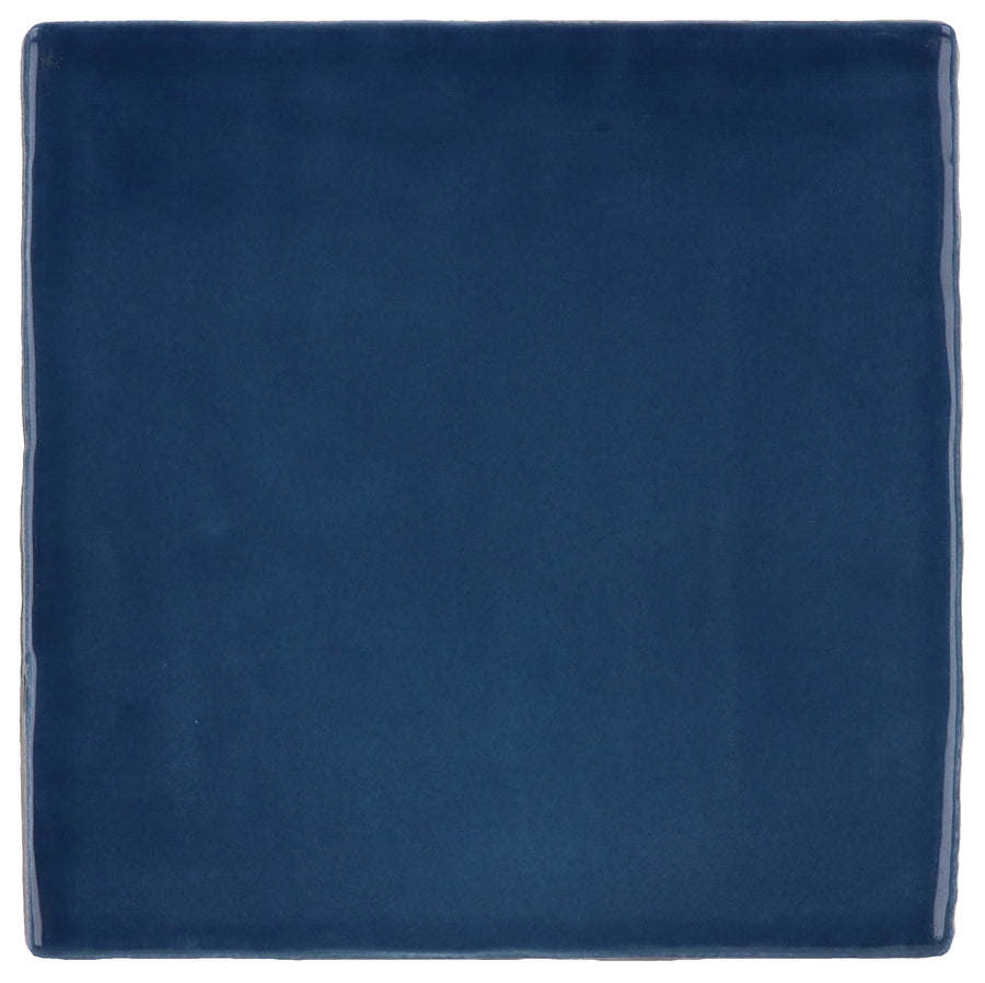 The Manacor 4" x 4" Ceramic Tile in Ocean Blue is a square tile with a smooth, slightly glossy finish and softly rounded edges, reflecting subtle Spanish elegance.