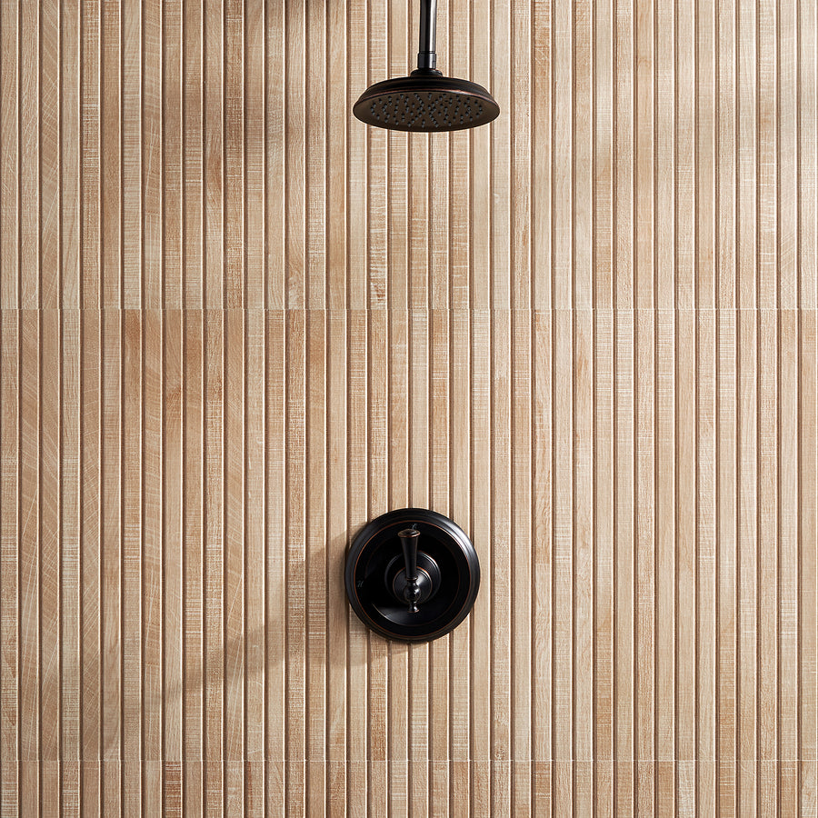 A black showerhead and matching control handle are mounted on a wall with vertical, light wood-look tiles featuring a textured, ribbed pattern.