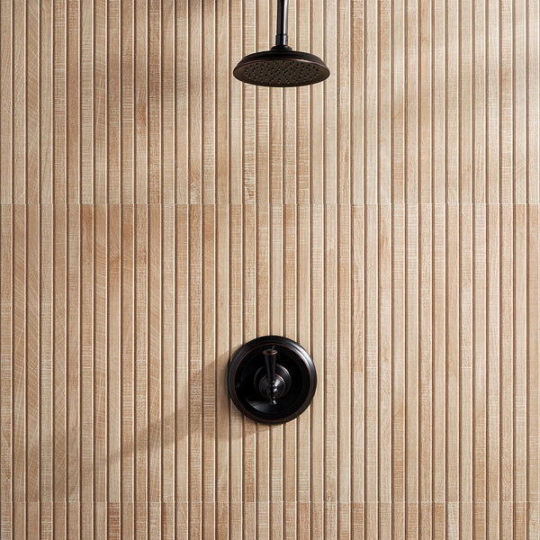 A black showerhead and matching control handle are mounted on a wall with vertical, light wood-look tiles featuring a textured, ribbed pattern.