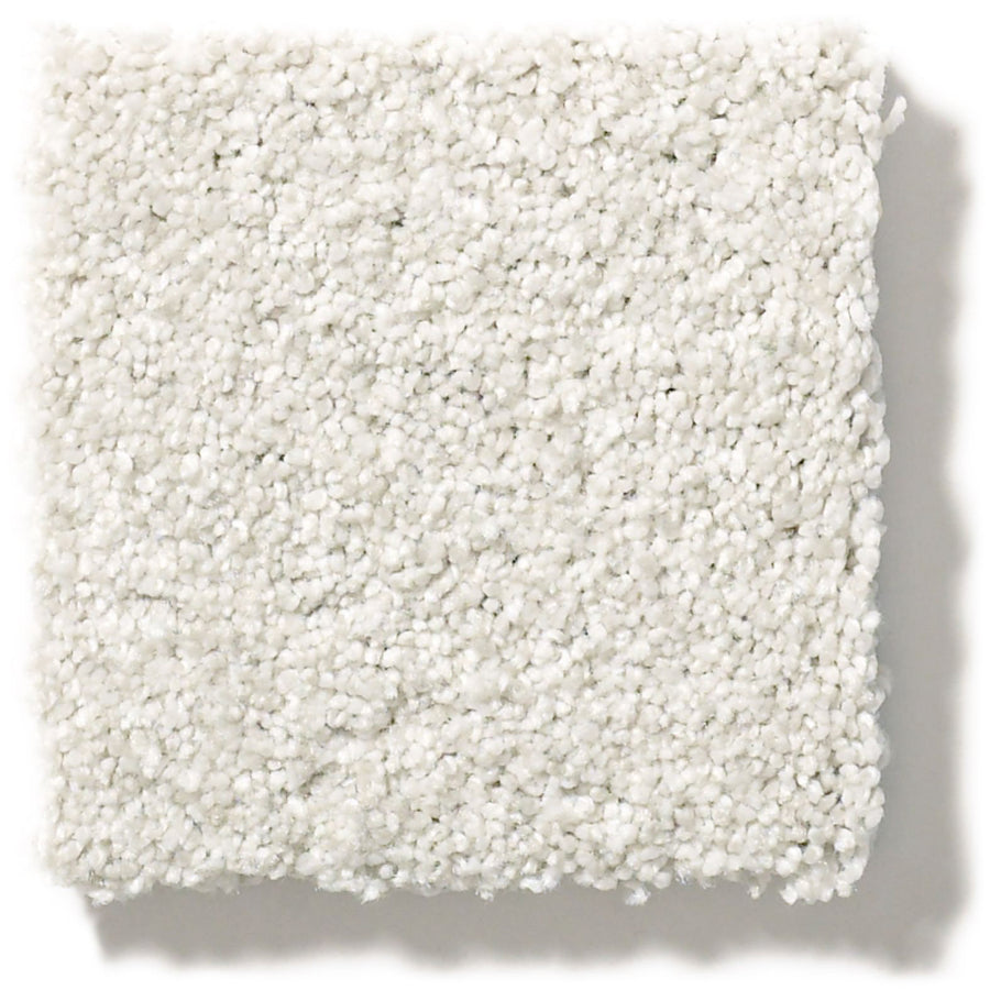 A close-up of a square swatch of Tonal Comfort Blue Family Friendly Carpet, featuring a soft, plush texture and white appearance, set against a plain white background.