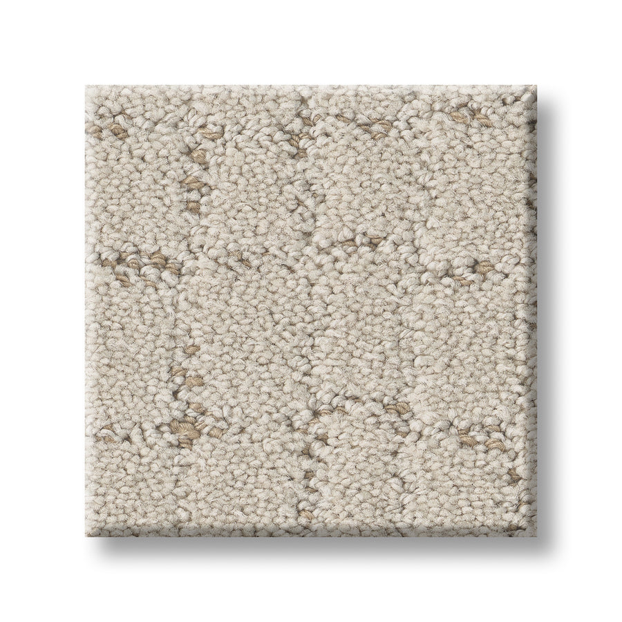 A square sample of Block Party Family Friendly Carpet in light beige with an elegant geometric pattern of raised and recessed squares and small darker beige flecks, shown against a plain white background.