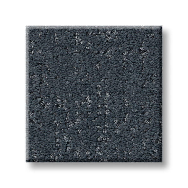 A square sample of Canvas Comfort Blue Family Friendly carpet in dark gray with a textured, irregular pattern is shown on a white background.