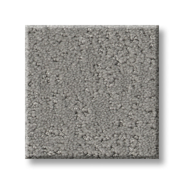 A square swatch of Canvas Comfort Blue Family Friendly carpet, featuring light gray, textured short loops, is displayed against a white background to highlight its stylish and durable design.