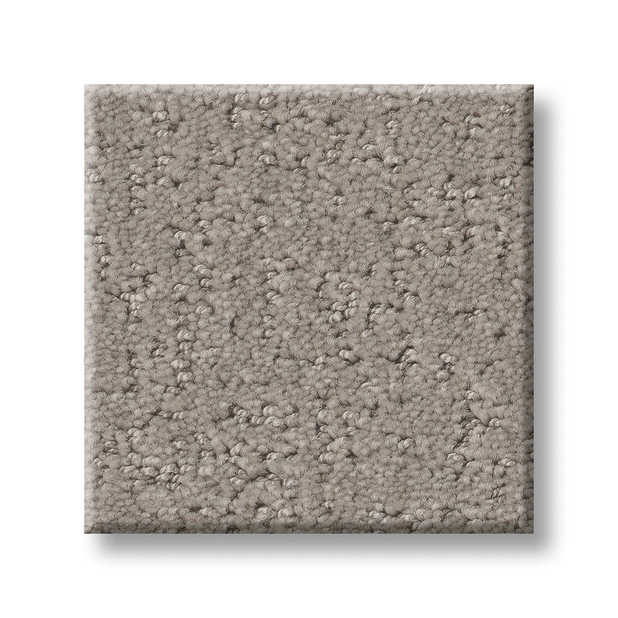 A square sample of Canvas Comfort Blue Family Friendly carpet, light brown with a textured mix of small loops and cut fibers, shown against a white background.