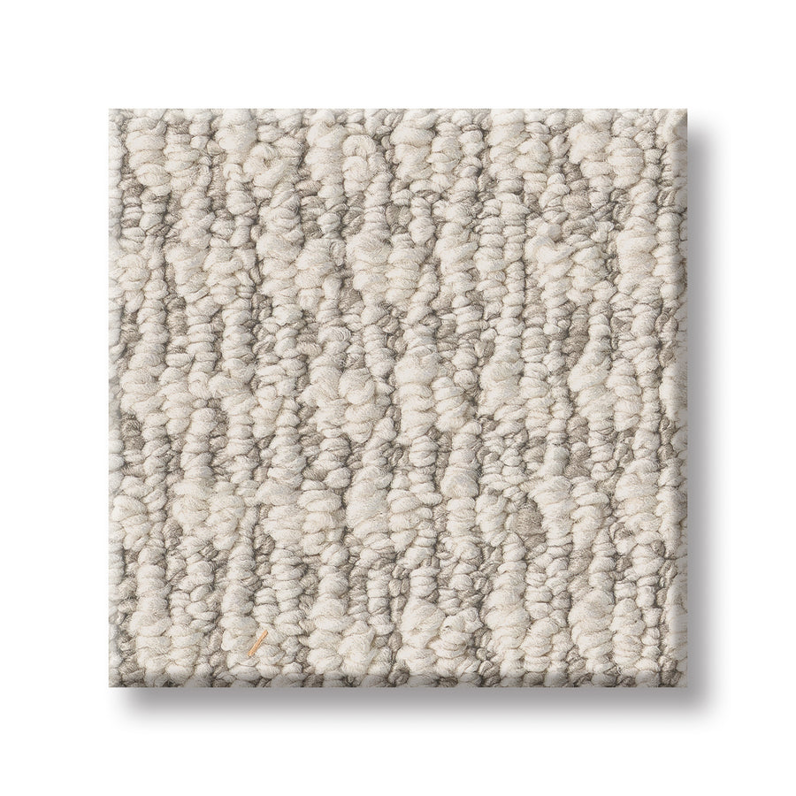 A close-up of Cozy Embrace Pet Friendly Carpet, featuring a textured, looped pattern in light beige and gray tones for comfort and style, shown on a white background.