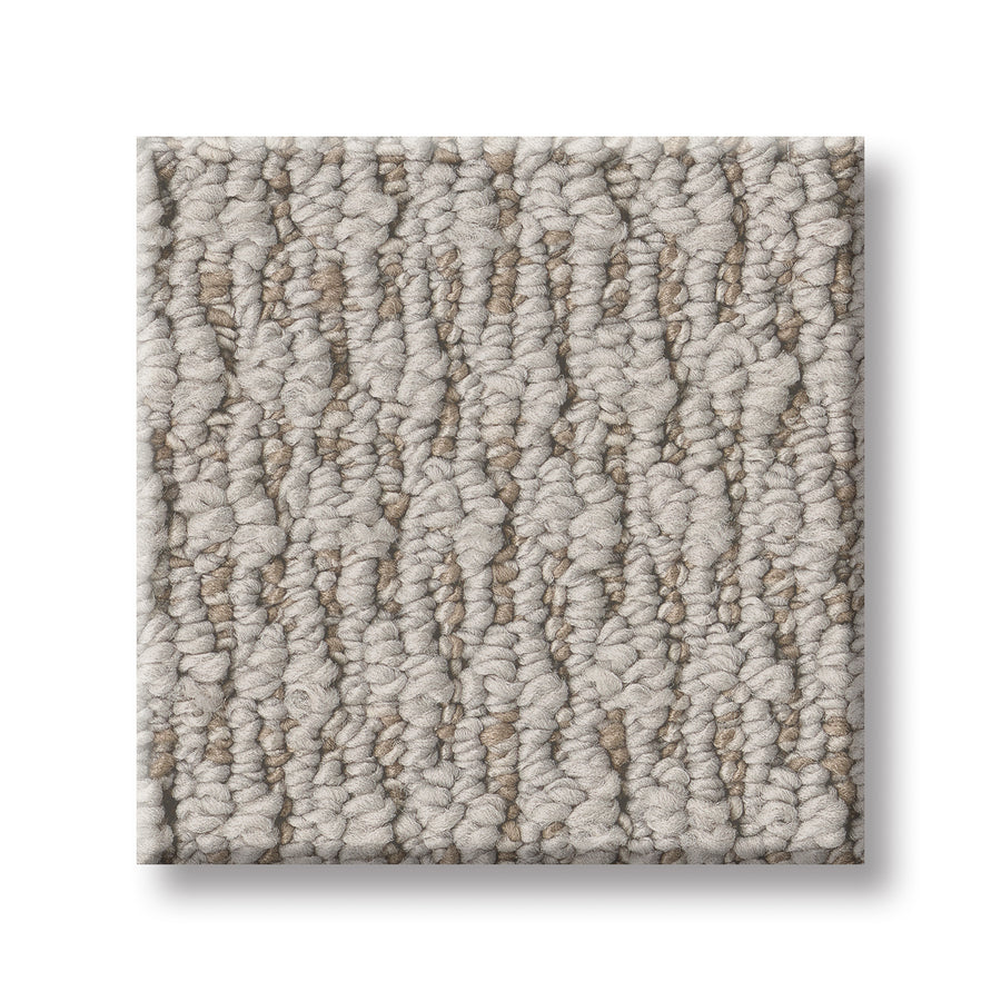 A square sample of Cozy Embrace Pet Friendly Carpet in light beige and taupe, featuring a subtle linear pattern and soft, dense fibers for comfort—shown on a white background.