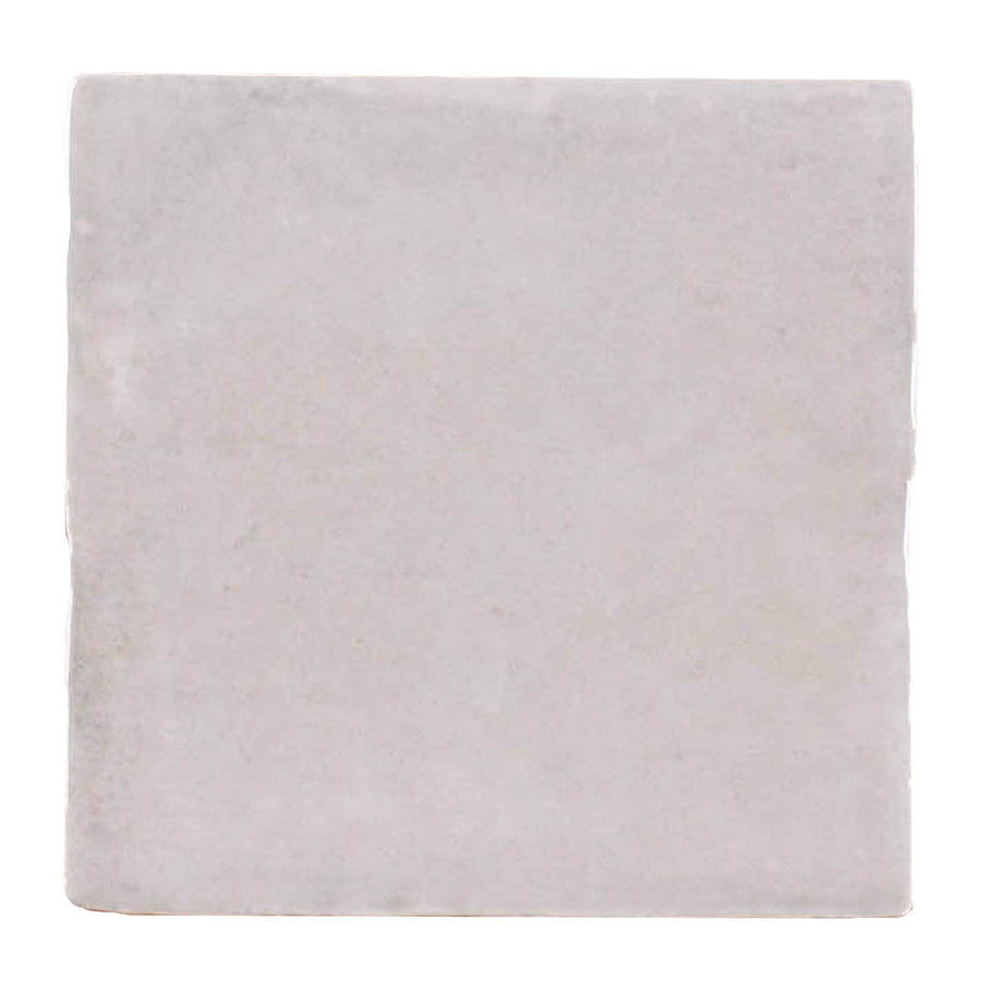 A single Martha's Manor 4" x 4" Square Ceramic Tile in Subtle Slate, featuring a light gray tone with a gently uneven surface and refined edges—ideal for elevating interiors with a touch of luxury.