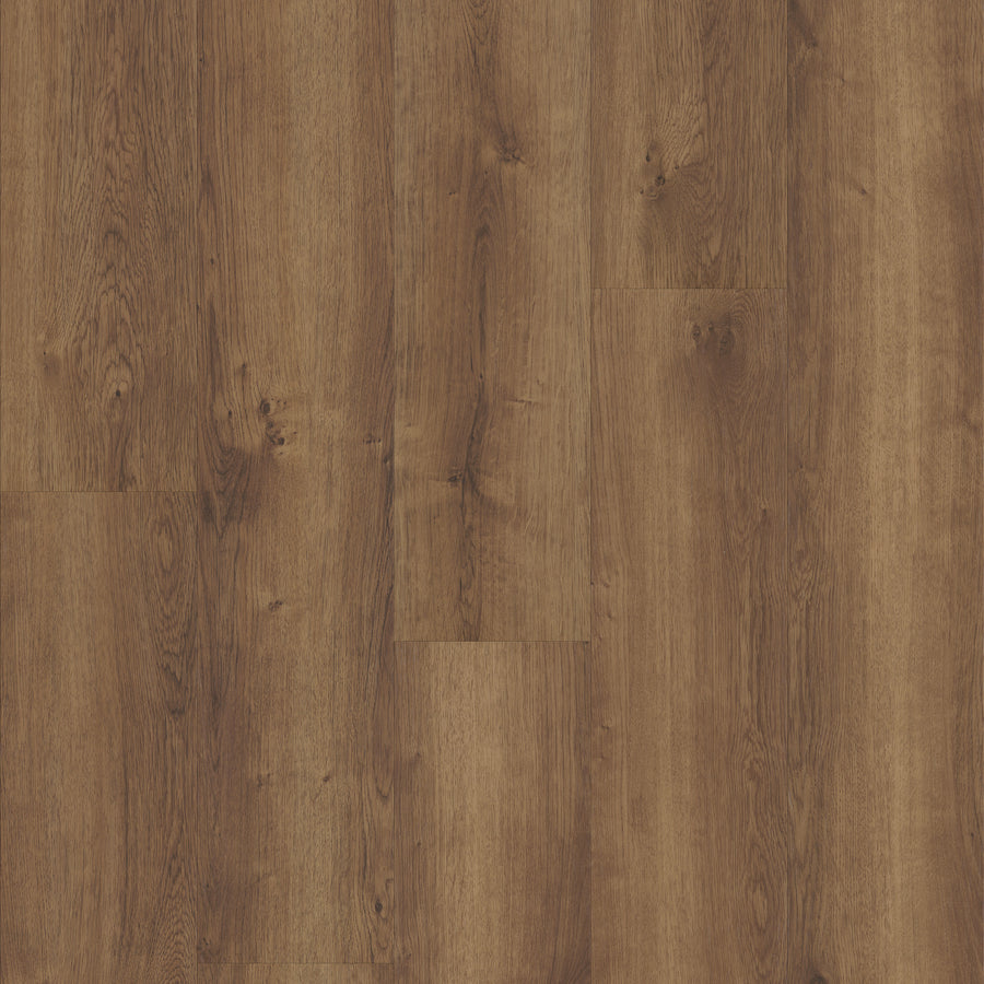 Close-up view of Coretec Pro Plus Vinyl luxury flooring featuring a warm brown tone, visible wood grain, and natural knots and patterns in a plank-style arrangement.
