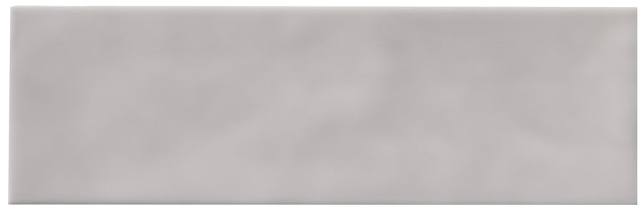 The Zephyr 2.5x8 Ceramic Tile is a rectangular, light gray tile with a smooth, slightly glossy finish and subtle Mediterranean-inspired shading variations. Special-order item.