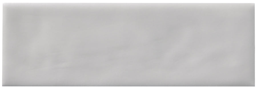 The Zephyr 2x6 Ceramic Tile features a plain, light gray rectangular surface with a soft matte texture and subtle shading, evoking the elegance of handcrafted luxury.