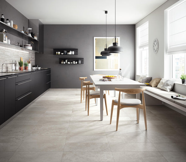 Modern kitchen and dining area with dark cabinets, open shelves, a white table and wooden chairs. Sunlight streams through large windows with white blinds. Minimalist decor and neutral tones create a bright, airy space.