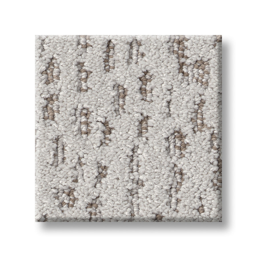 The Ambitious On Trend Carpet sample features a square shape with a light beige base and scattered brown and tan spots for a subtle, textured look. Shown here on a white background.