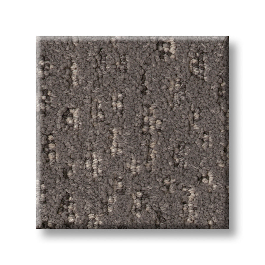 A close-up of the Ambitious On Trend Carpet swatch shows its square shape and textured looped pattern in gray and taupe tones, set against a white background.